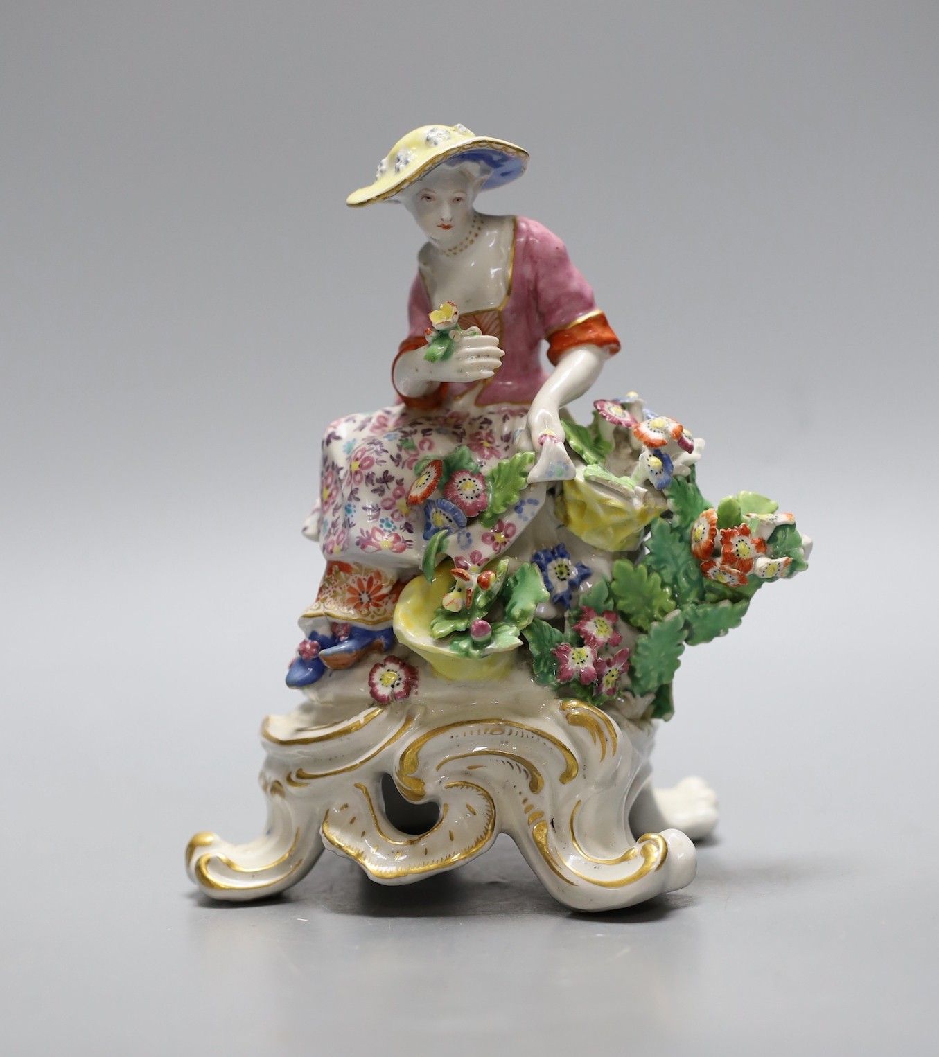 A Bow good figure of Spring on a scroll moulded base painted with flowers, having an anchor dagger mark in red, 16 cms high